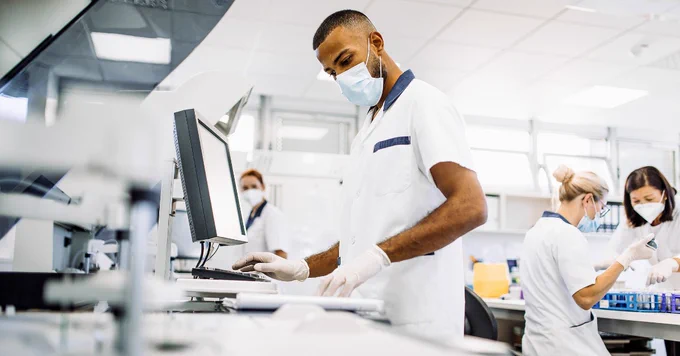 An image of a group of scientists conducting tests in a laboratory.