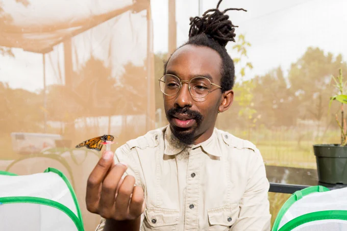 D. André Green II ’08 holds a monarch butterfly. 