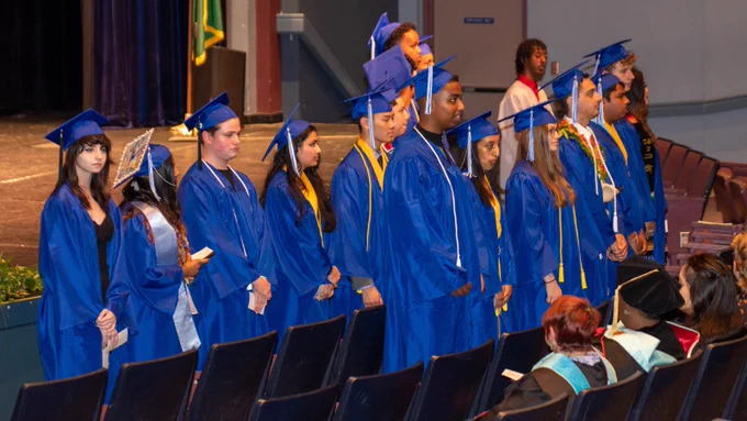 students standing at graduation