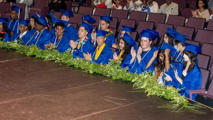 students clapping at graduation