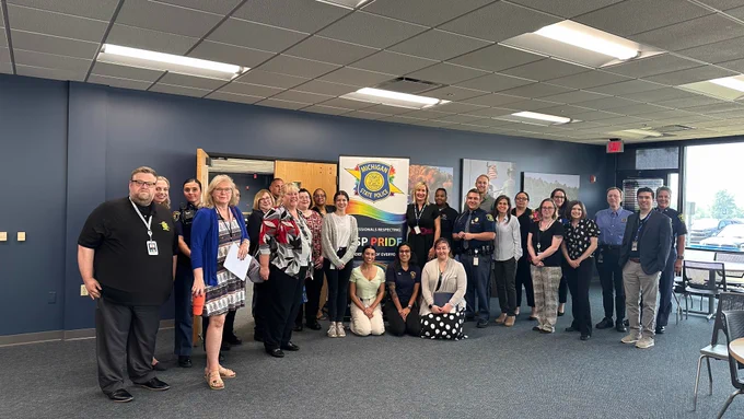 A group photo of members and allies of the MSP Professionals Respecting the Identities of Everyone (P.R.I.D.E.) Employee Resource Group (ERG).