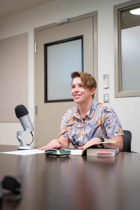 Kari Dockendorff smiles in front of a microphone.