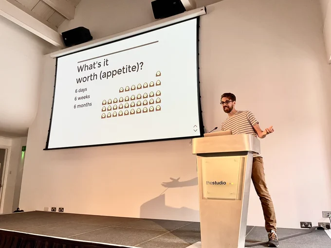 Me on a podium with a slide about Shape Up