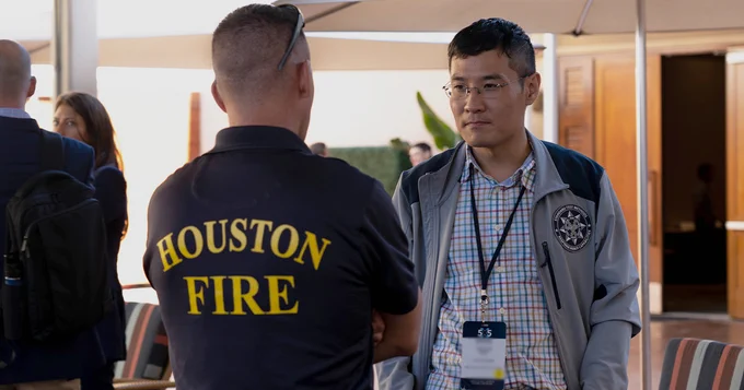 A Houston Fire official speaking with a participant of 5x5: The Public Safety Innovation Summit