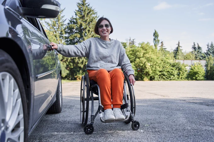 Wheelchair user with her car