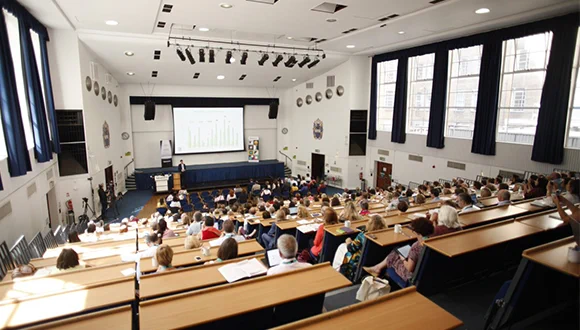 Picture of people in a lecture hall attending a conference
