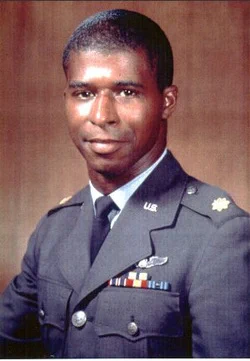 USAF Major Robert H. Lawrence smiles for a formal portrait. He is dressed in gray uniform.