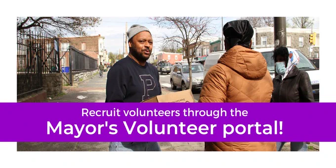 Graphic with a photo framed in white of two volunteers passing a box of packed foods; the person on the left is facing the camera and the other person on the right is facing away. White text over a purple box at the bottom reads, “Recruit volunteers through the Mayor’s Volunteer portal.”