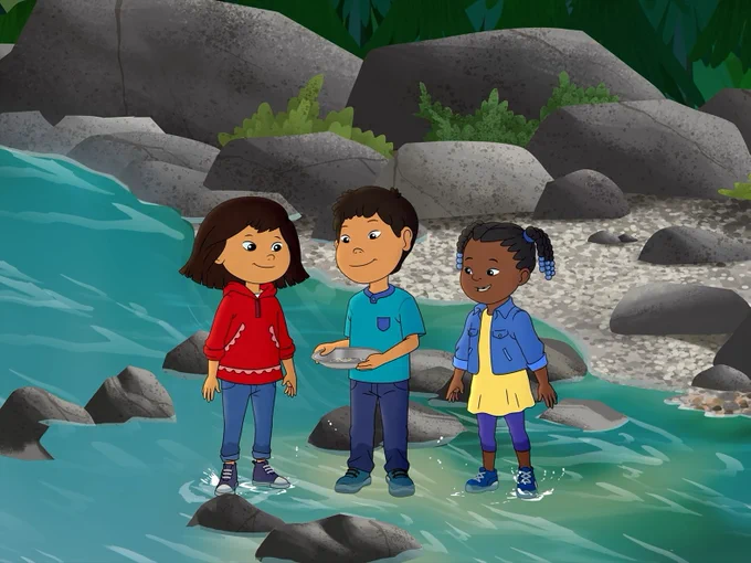 Molly, Tooey, and Trini stand in a creek smiling as they look down at a tin in Tooey's hands.