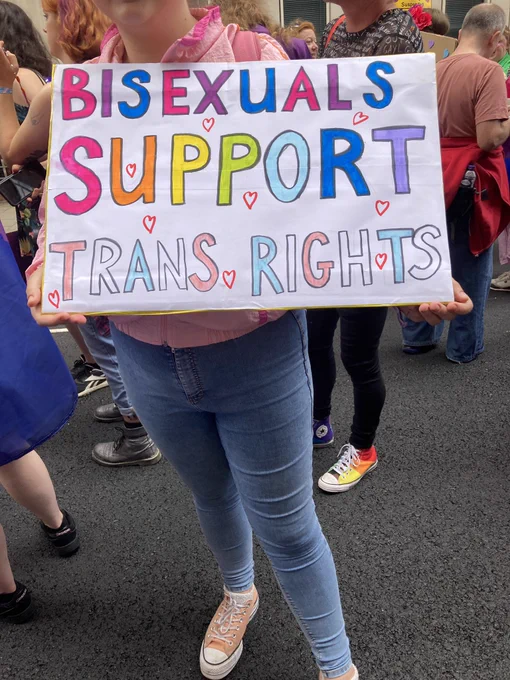 Multi coloured placard: “bisexuals support trans rights”
