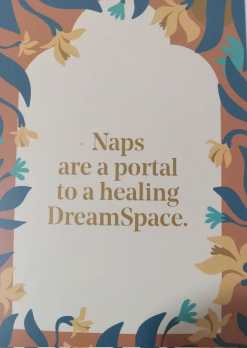 Card from The Nap Ministry Rest Deck with brown text on a tan background with floral border reads: "Naps are a portal to a healing DreamSpace."