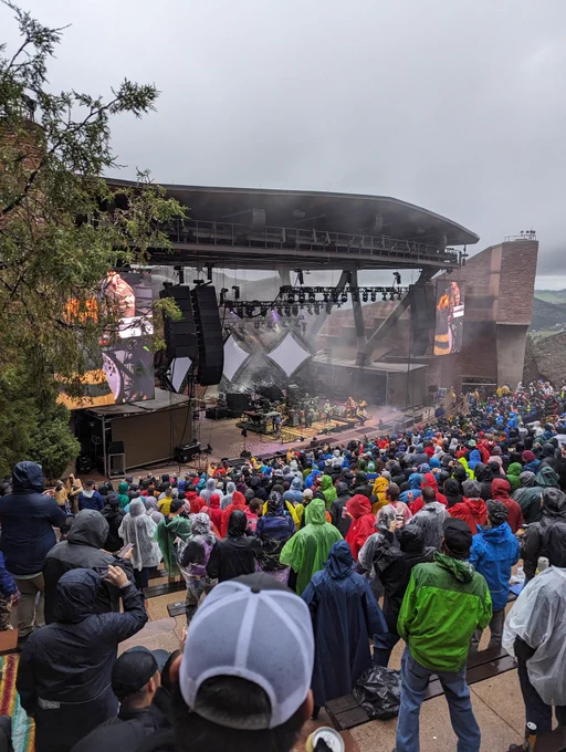 A concert at Red Rocks Amphitheater featuring the band moe it's rainy and foggy from 21 rows up