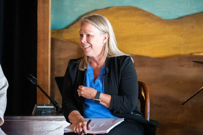 Ann Ellefson, Director, Office of Academic Support with ND Department of Public Instruction sits on a stage and speaks to the audience.