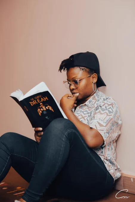 A female book lover enjoying “The Usurpers Dream by Yeayi Kobinah” at a quiet place