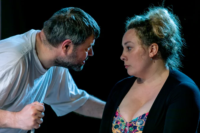 Steven George bends down to Helen George, their eyes are locked as he pleads with her.