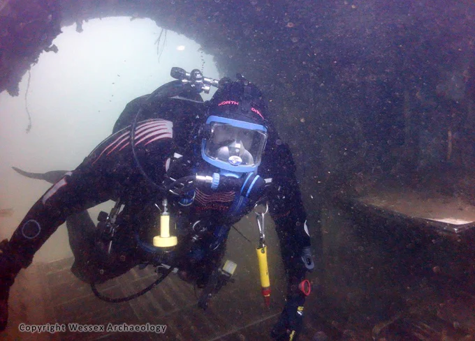 An archaeologist exploring an underwater wreck.