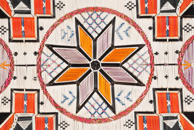 Porcupine Quill-Work Chair back decorated with a mosaic of white, red, black, orange, blue, lavender and pink aniline-dyed porcupine quills. The eight-pointed star, a common motif on 19th-century quillwork and continues to be popular in contemporary Mi’kmaw designs. 
