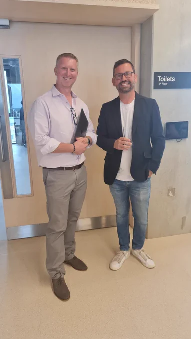 Two men stood next to each other 