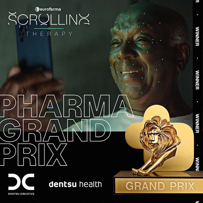 Image of Black man holding his phone away from his face and smiling at the screen. Text on the image is a Grand Prix Cannes Lion with more text directly to the left that reads: "Pharma Grand Prix."
