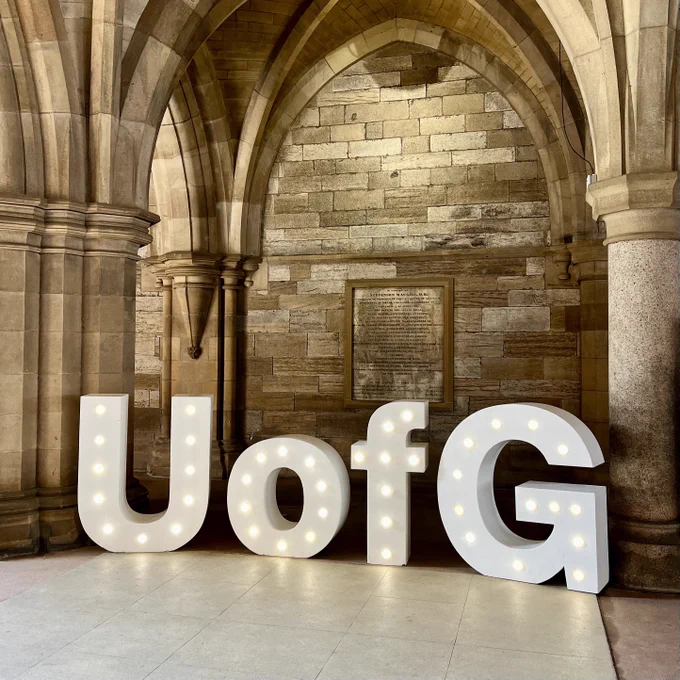 Big letters that spell out U of G, in the cloisters at the University of Glasgow.