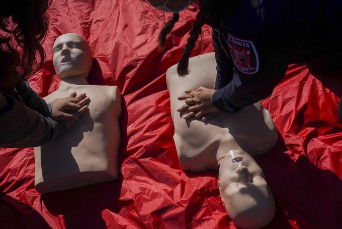 Two people practicing CPR.