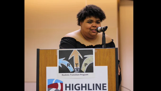 Student speaker at podium and RTP sign above Highline logo/sign