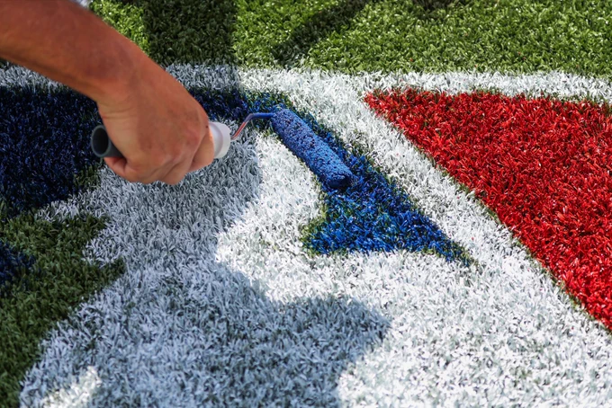 The finishing touches are put on the painted MLB logo on the field at London Stadium.
