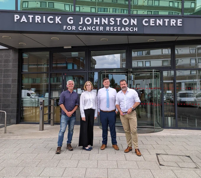 Prof Stephen Tait, Prof Dan Longley and Dr Emma Evergren pose outside PGJCCR front door with new doctor James Holloway