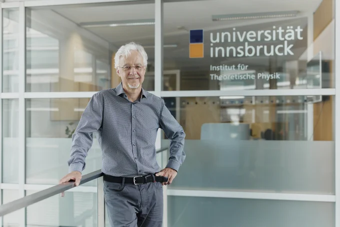 Hans Briegel in front of the entrance to the Department of Theoretical Physics