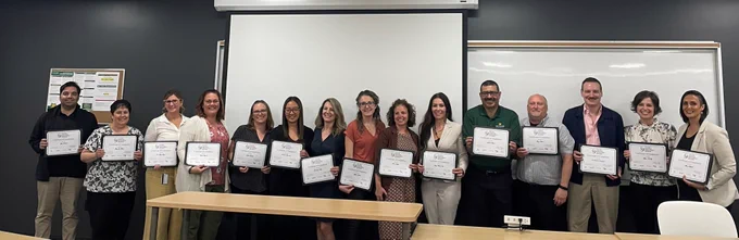 A group of St. Clair College faculty holding up their CEDP certificates. 