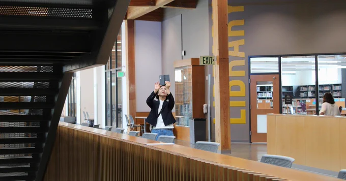 Photo of person taking a photo of commons area of HHS.