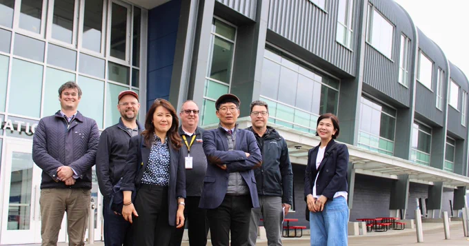 Photo of 7 people in front of RAHS building.