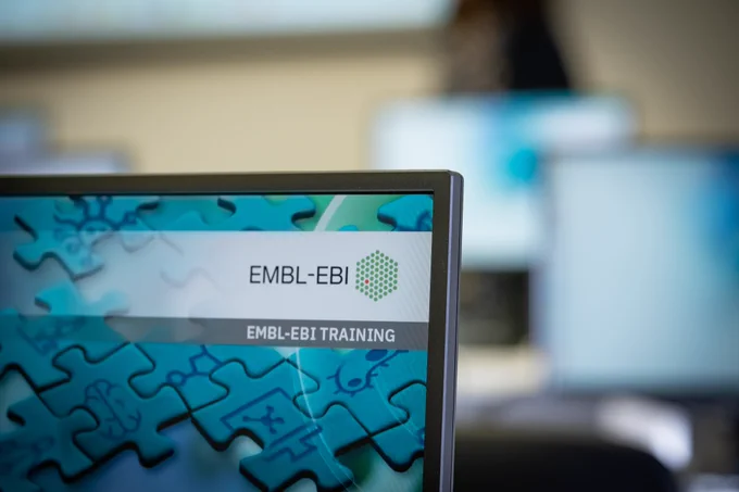 A computer screen shows the EMBL-EBI logo and the words EMBL-EBI Training