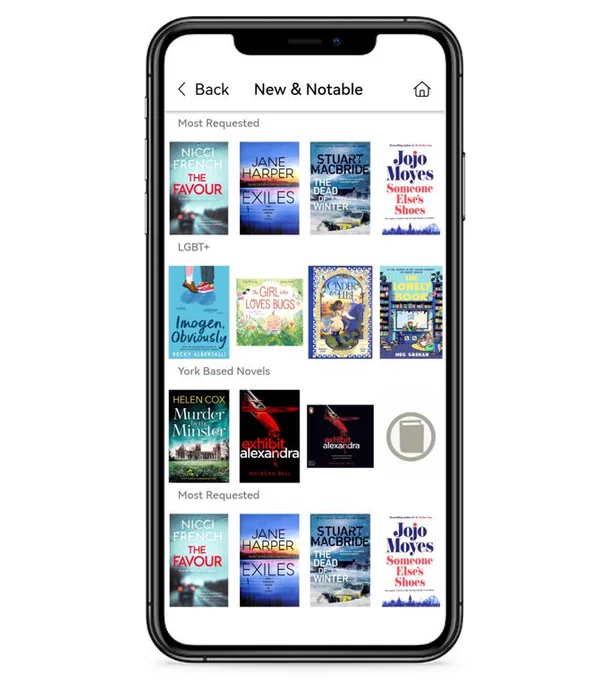 A phone with it's screen showing the Explore York Libraries App. The page shows the front covers of books that are 'New and Notable' in the catalogue