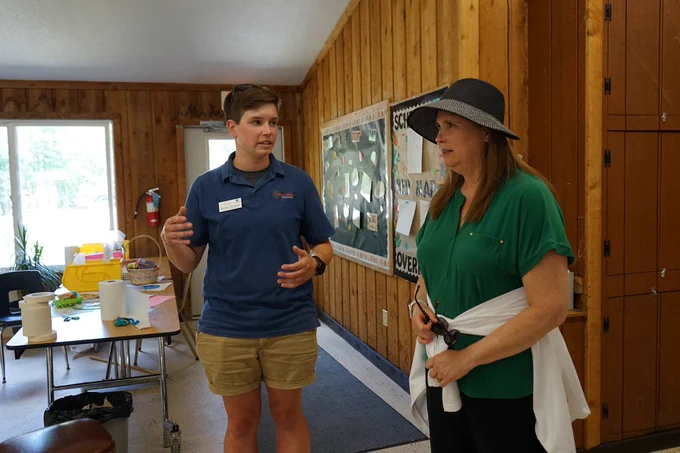 Anna Korb, AmeriCorps program manager at the Easterseals Camp, tells DOA Secretary Kathy Blumenfeld about the camp’s operations and facilities.