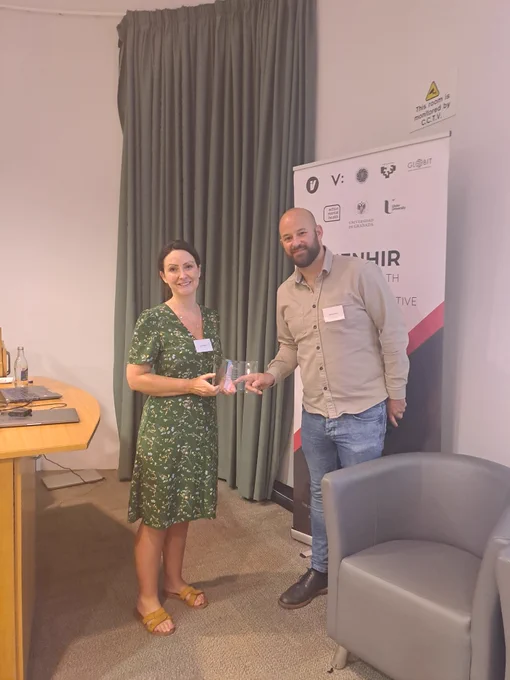 A photo of Ciara McCabe accepting a keynote award from Raymond Bond.