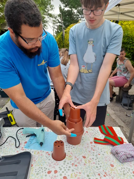 Omar, a session leader, helps Mackenzie make a gnome