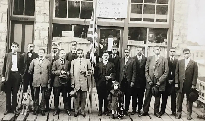The Colored Department of Norfolk and Western Railroad Y.M.C.A. photograph, AC 266, depicts 15 African Americans standing in front of a building with a sign reading "Colored Department / N. [and] W. R.R. Y.M.C.A. / A Farewell to the / Colored Liberty / Fellows by the / Y.M.C.A. / Oct. 28 330 pm."  This photograph was taken circa 1920s.