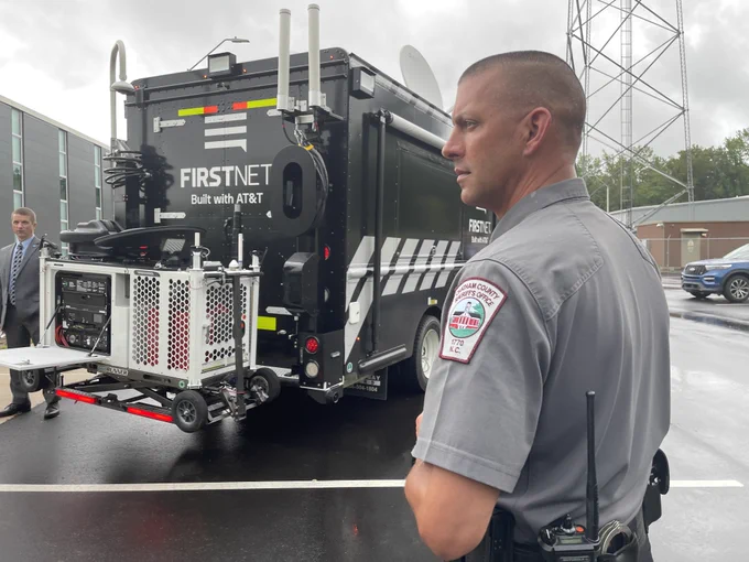 North Carolina public safety official stands in front of FirstNet command vehicle with compact rapid deployable