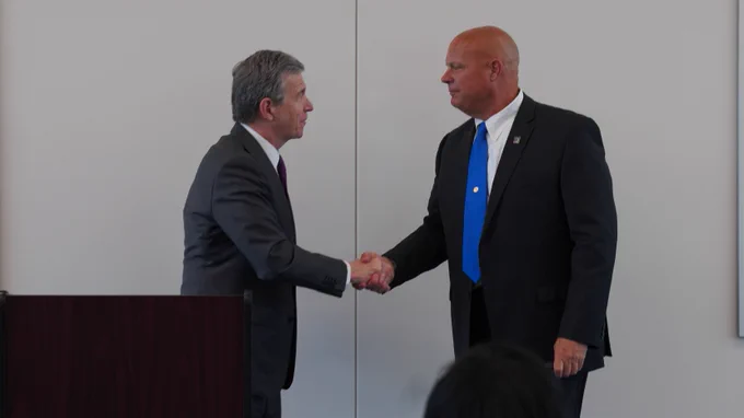 North Carolina Governor Roy Cooper shakes hands with FirstNet Authority Senior Public Safety Advisor Jon Olson