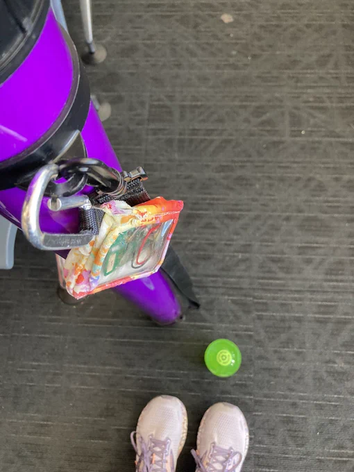 My #OpenAPS rig (an open source automated insulin delivery system) clipped to my purple poster tube for #ADA2023. A diet Mtn dew and my purple sneakers are also in view.