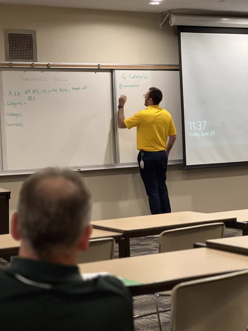 Brian Nairn writes at the whiteboard.