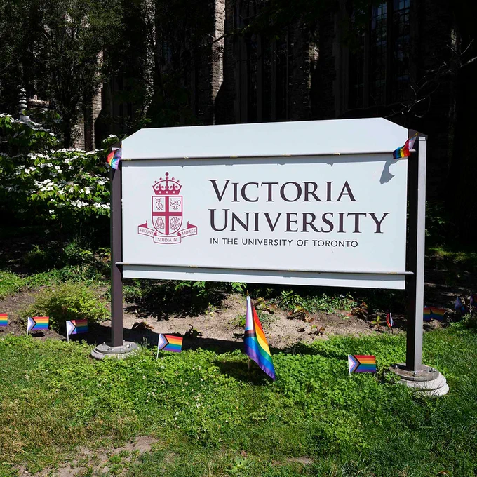 The Victoria University sign on the corner of Charles Street is adorned with Pride flags.