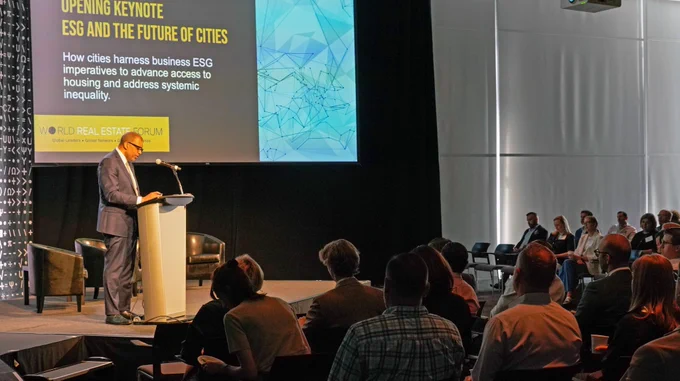 keynote speaker james jemison from boston planning and development authority speaking on stage at a podium on "ESG and the future of Cities: How cities harness business ESG imperatives to advance access to housing and address systemic inequality"