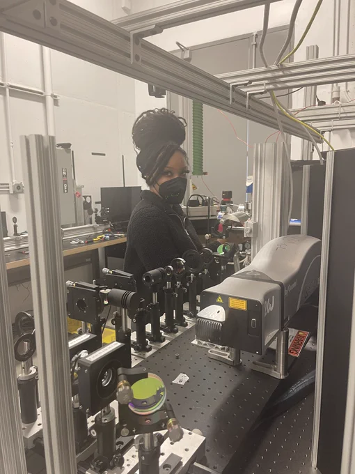 Woman working on optical equipment