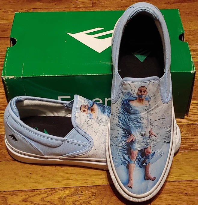 A pair of skate shoes, Emerica branded, with custom artwork of Steve-O duct taped to the shoe.