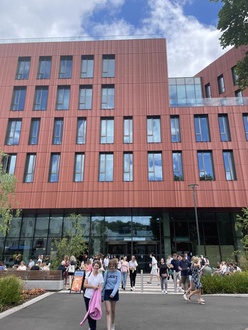 The Faculty of Arts Building with prospective students and their families walking nearby