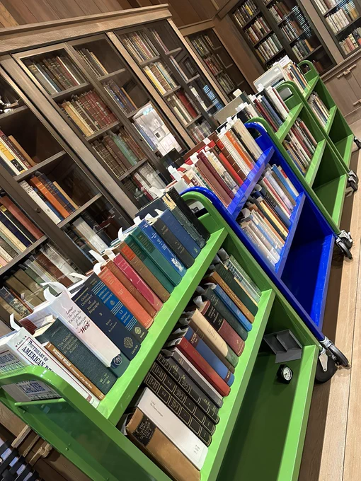 Four book trucks filled with bibliographies and reference sources