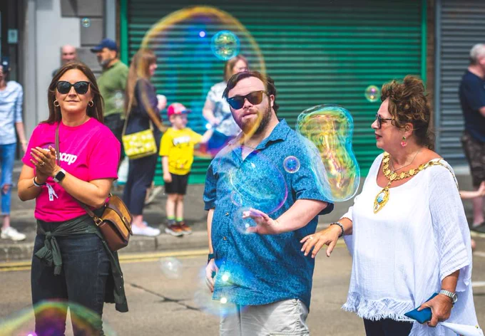 Actor James Martin and Alderman Gerardine Mulvenna leading the Disability Pride Carnival Parade in Carrickfergus 
