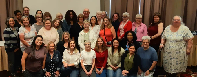 A group of smiling VAST volunteers at our summer volunteer appreciation event.